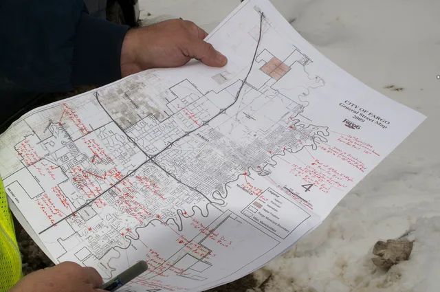Fargo, ND, April 1, 2009 -- Harold Pedersen, the man responsible for placing and maintaining the pumps for flood control in Fargo, ND , holds a map with the location of pumps being used to control water removal. Photo by Patsy Lynch/FEMA. Flood and Fire Maps for Vacation Rental Owners: Reading Risk Before You Buy